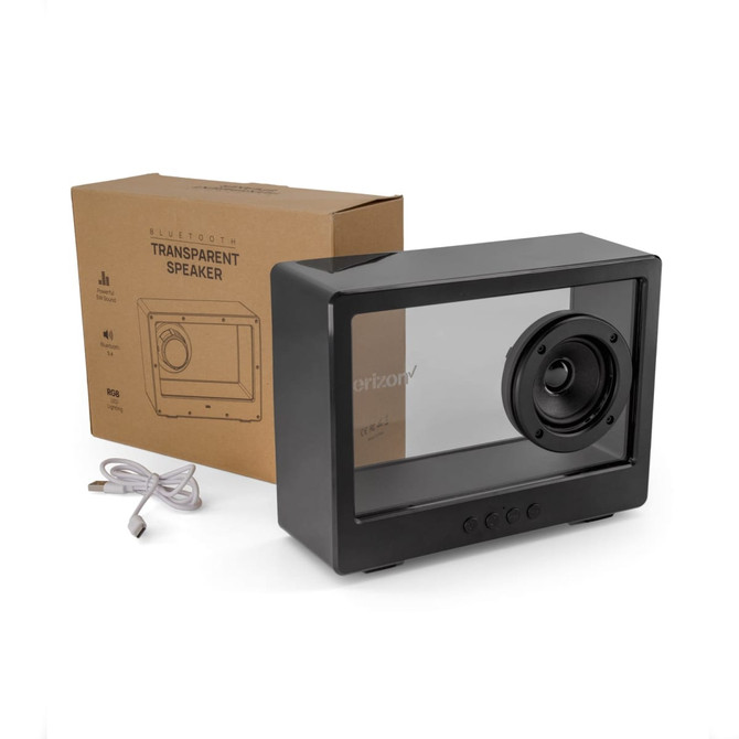 A black transparent speaker sits beside a cardboard box and a charging cable.