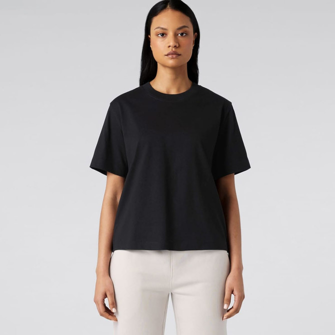 A black T-shirt displayed on a model, featuring a relaxed fit and short sleeves, without any visible logos.