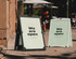 A-frame signs in black and white display the message "We are open." The signs are positioned outdoors on a pavement.