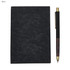 A black notebook with a textured cover and a black pen with a wooden accent, featuring a logo.