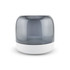 A grey and white speaker with a rounded design and a transparent top, featuring a branding logo.