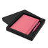 A pink notebook with a matching pen, presented in a black gift box.