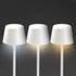 A set of three white, rechargeable table lamps with varying light shades on a dark background.
