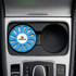 A blue air freshener labelled with a logo, placed in a car's cup holder alongside an empty compartment.