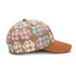 A brown cap featuring a full-colour patch with multicoloured paw print patterns. It has a logo on the side.