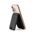 A black phone wallet attached to the back of a smartphone, designed for carrying cards or cash.
