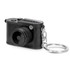 A black mini camera keychain with a keyring attachment and detailed lens design. It features a textured surface.