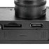 A black mini camera featuring a lens, a memory card slot, and a USB-C port.
