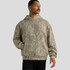 A faded camo hoodie in shades of green and brown, featuring a front pocket and a hood. It has a logo on it.