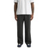A pair of relaxed, cuffless track pants in black, worn with a white shirt and athletic shoes.