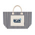 A striped tote bag in navy and cream featuring a front pocket and a logo. It has sturdy handles for carrying.