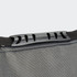 A grey cooler bag with a black adjustable strap and clip closure, featuring a textured surface and branding.