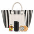 A black and white striped tote bag with a pocket, containing a jar of sweets, a black drink bottle, and a wooden item.