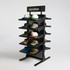 A black hat rack featuring multiple shelves, displaying a variety of caps in different colours and styles.
