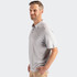 A grey men's polo shirt is displayed, featuring a collar, short sleeves, and a logo on the chest.