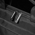 A close-up of a black laptop bag featuring dual silver zippers and a textured exterior.