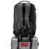 A black Swiss Digital Java Backpack is positioned on top of a silver suitcase. The backpack has a branding logo.