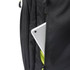 A sleek black backpack features a tablet partially visible in a zipped compartment, accented by vibrant green interior.