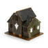 A wooden model of a spooky house in green and brown, featuring ghost decorations and pumpkins, with spiderwebs.