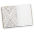 An open notebook featuring a geometric patterned design on the left page and lined pages on the right.