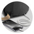 A black bag with a charging cable connected, positioned next to a smartphone on a surface.