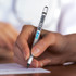 A hand holding a silver stylus pen with a black tip, poised above a piece of paper. The pen features a branding logo.
