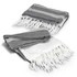 A grey and white throw blanket with fringed edges, featuring a patterned design. The image includes two folded blankets.