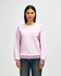 A pink Gildan Heavy Blend adult crewneck sweatshirt on a model, featuring a relaxed fit and long sleeves.