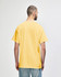 A yellow Gildan Heavy Cotton adult T-shirt is displayed from the back, featuring a relaxed fit.