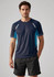 A navy short sleeve tee featuring blue accents and reflective elements. The model is wearing black shorts.