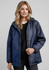 A navy unisex Spinnaker jacket with a hood, featuring a logo. The model is wearing it over a black top.