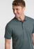 A short sleeve polo shirt in a muted green shade, featuring a collar and buttons, with a logo on the chest.