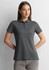 A women's short sleeve polo shirt in dark grey, featuring a collar and button placket, with a logo on the chest.