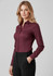 A maroon women's long sleeve button-up shirt, featuring a classic collar and fitted silhouette, paired with black trousers.