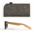 A pair of black sunglasses with bamboo arms, accompanied by a grey felt case.
