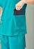 A turquoise women's scrub top featuring two large pockets, one holding a tablet or similar device.