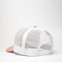 A trucker cap featuring a pink front panel and white mesh back. It has a snapback closure and a logo.