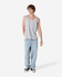 A grey unisex fine jersey tank top is worn with light blue jeans and black sneakers, featuring a logo.