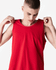 A red unisex fine jersey tank top being adjusted by a model, featuring a simple design and a logo.