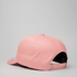 A pink snapback cap featuring a curved peak and adjustable back strap, showcasing its simple yet stylish design.