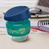 A drink bottle made of clear borosilicate glass, featuring a teal silicone sleeve and a blue lid.