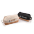 A beige and black utility pouch with cork base, featuring a logo, ideal for toiletries and accessories.