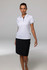 A model wears a white polo shirt paired with a black skirt. The polo has a logo on it.