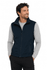 A navy men's vest with a zip front and pockets, worn over a light grey long-sleeve top.