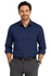 A long sleeve button-up shirt in navy blue with a chest pocket, worn by a man standing with hands in pockets.
