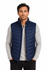 A navy blue puffer vest with a zip closure and a logo, worn over a light grey shirt.