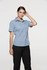 A short-sleeve blue button-up shirt on a model, styled with black pants. The shirt features a collar and has a logo.