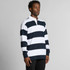 A rugby stripe polo shirt featuring navy and white horizontal stripes and a collar, displayed by a model.