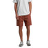 A pair of 18-inch walk shorts in a rust colour with a drawstring waist and side pockets. Features branding on the side.