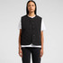 A black quilted vest with a round neckline and button closure, worn over a white t-shirt.